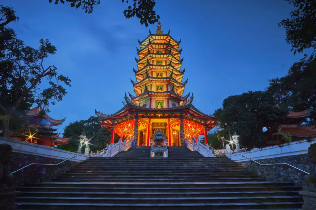 Beautiful pagoda in the evening under blue sky. The pagoda is surrounded by trees, Semarang, Indonesia