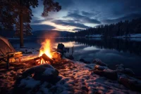 Camping on the shore of Lake Tahoe in winter, California, Camp by the lake with campfire in winter at dusk,